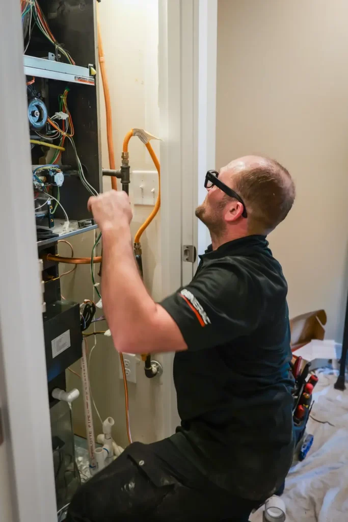 Technician working on electrical panel